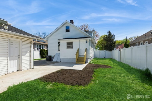 back of property featuring entry steps, a patio, a chimney, and central AC unit
