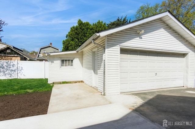 exterior space with fence and a garage