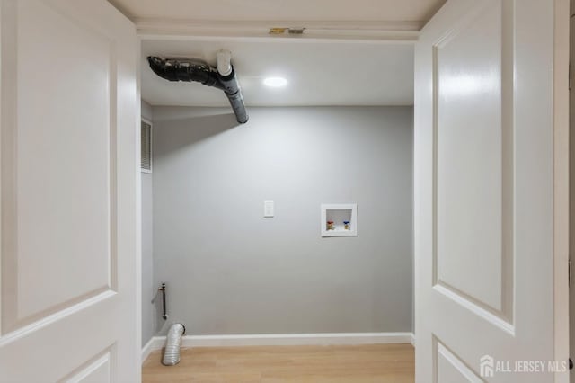 laundry room with recessed lighting, baseboards, hookup for a washing machine, wood finished floors, and laundry area