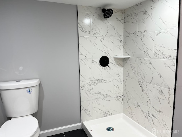 bathroom with toilet and a shower stall