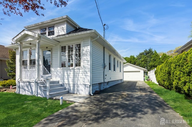 26 Meeker Ave, Edison, NJ 08817 - view of front facade with an outdoor structure, a detached garage, and a front lawn