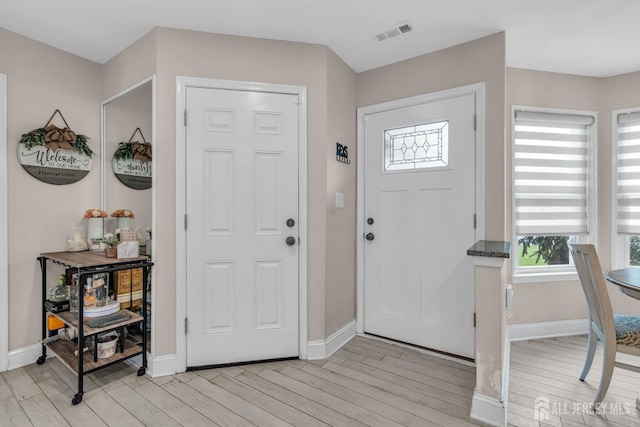 103 Rumford Way, Manalapan, NJ 07726 - foyer entrance featuring light wood-style floors, plenty of natural light, and baseboards
