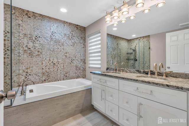 103 Rumford Way, Manalapan, NJ 07726 - bathroom with a stall shower, double vanity, a garden tub, recessed lighting, and wood finished floors