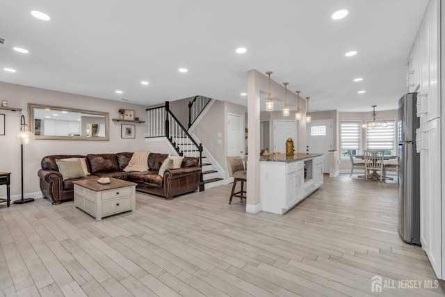 103 Rumford Way, Manalapan, NJ 07726 - living room with baseboards, stairs, light wood-type flooring, a chandelier, and recessed lighting