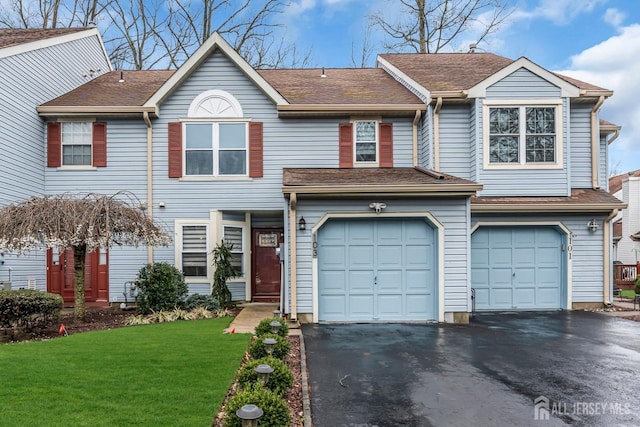 103 Rumford Way, Manalapan, NJ 07726 - view of property with asphalt driveway, an attached garage, and a front lawn