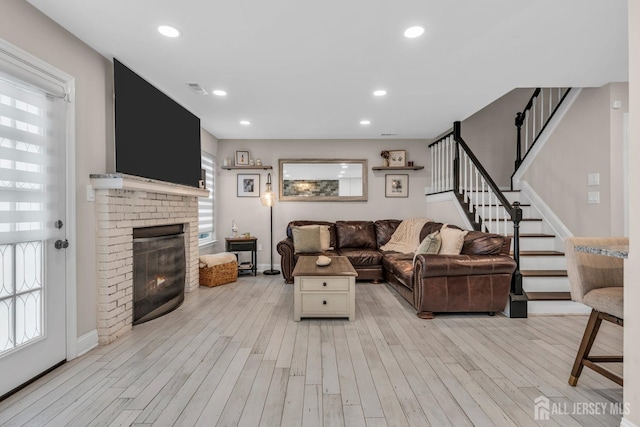 103 Rumford Way, Manalapan, NJ 07726 - living room featuring light wood-type flooring, a fireplace, stairs, recessed lighting, and baseboards