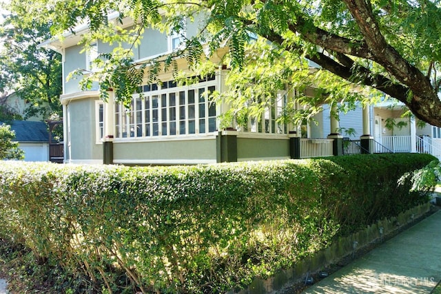 view of side of home with stucco siding