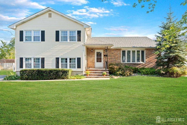 tri-level home featuring a front yard