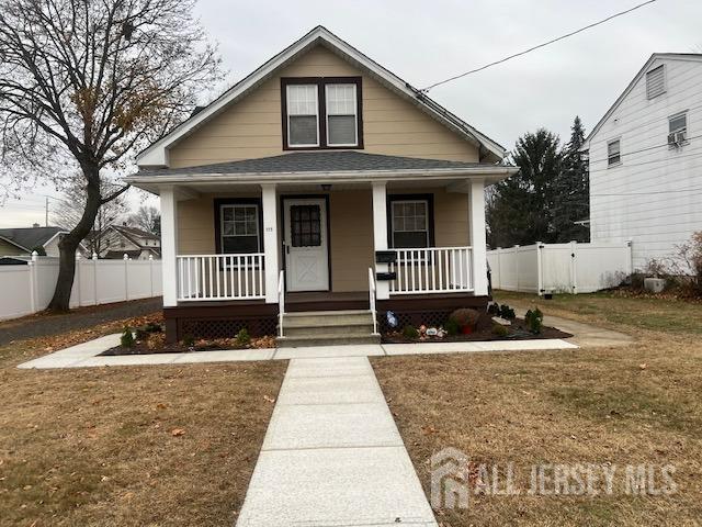 bungalow-style house featuring a front lawn and covered porch