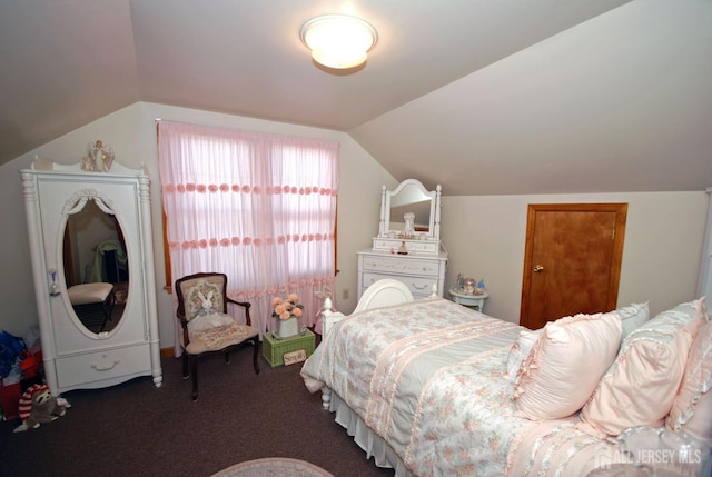 bedroom featuring dark carpet and vaulted ceiling