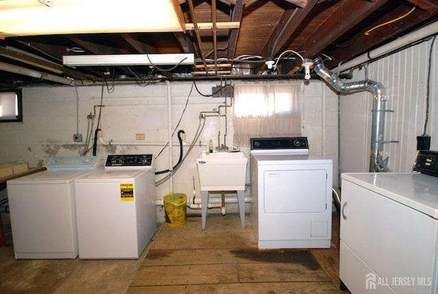 clothes washing area with sink and washing machine and clothes dryer