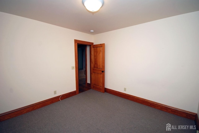 empty room with dark carpet