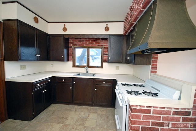 kitchen with sink, dark brown cabinets, range hood, and white range with gas stovetop