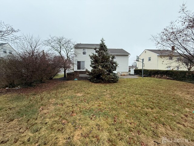 rear view of house with a lawn