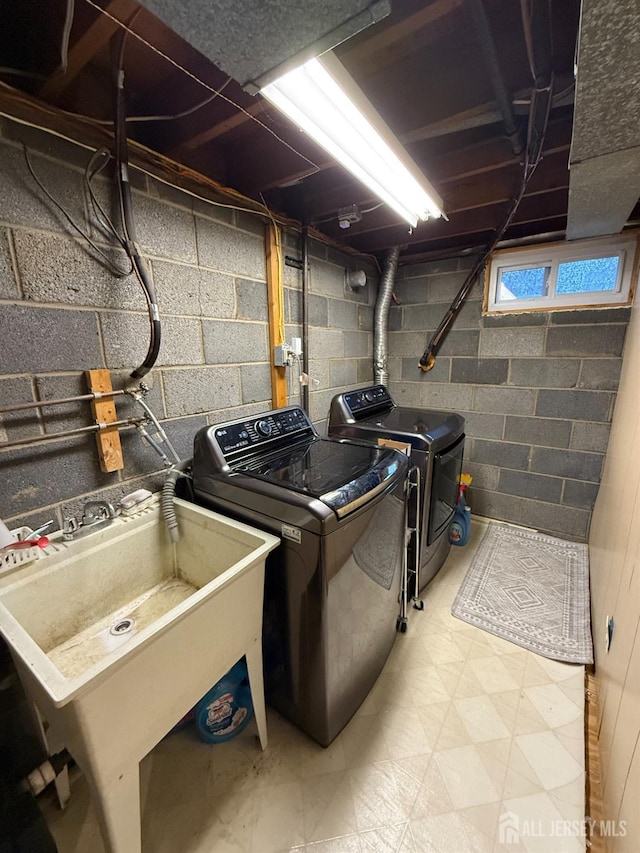 laundry area with washing machine and dryer and sink