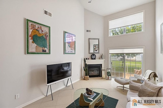 6503 Schindler Dr, South Brunswick, NJ 08852 - tiled living area featuring a high ceiling and a glass covered fireplace