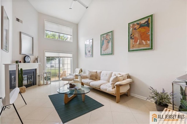 6503 Schindler Dr, South Brunswick, NJ 08852 - living room featuring high vaulted ceiling, a ceiling fan, a glass covered fireplace, and tile patterned flooring