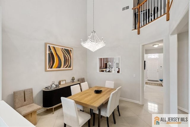 6503 Schindler Dr, South Brunswick, NJ 08852 - dining room with a high ceiling, a chandelier, and light tile patterned floors