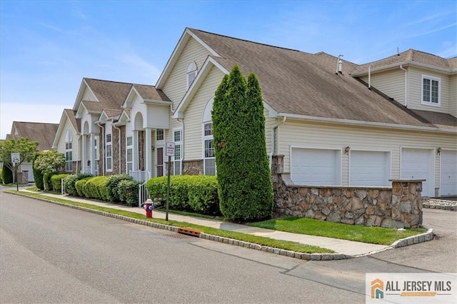 6503 Schindler Dr, South Brunswick, NJ 08852 - view of front of house featuring stone siding, an attached garage, and a shingled roof