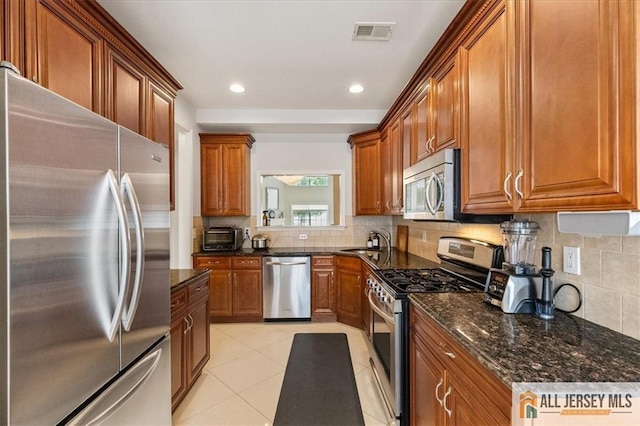 6503 Schindler Dr, South Brunswick, NJ 08852 - kitchen featuring stainless steel appliances, brown cabinetry, backsplash, and recessed lighting