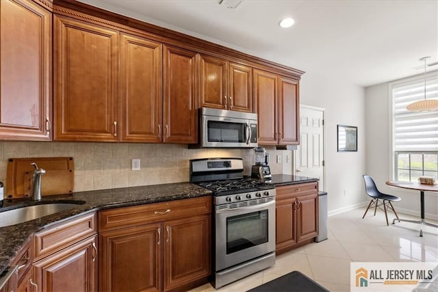 6503 Schindler Dr, South Brunswick, NJ 08852 - kitchen with stainless steel appliances, brown cabinetry, tasteful backsplash, dark stone counters, and recessed lighting
