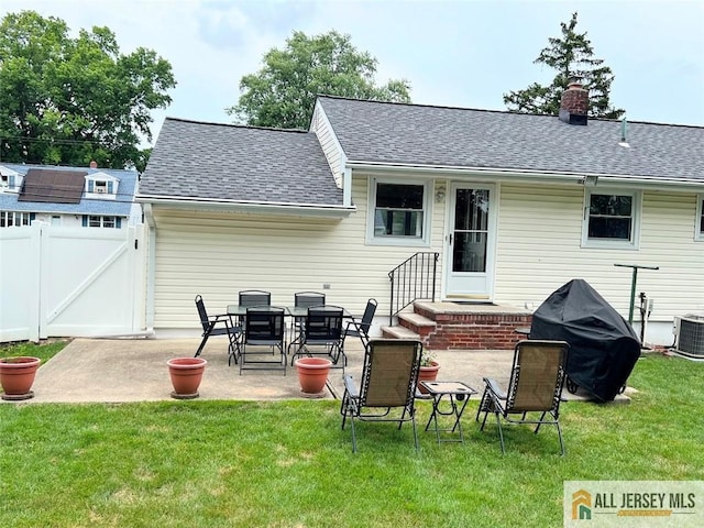 back of house featuring a patio and a yard