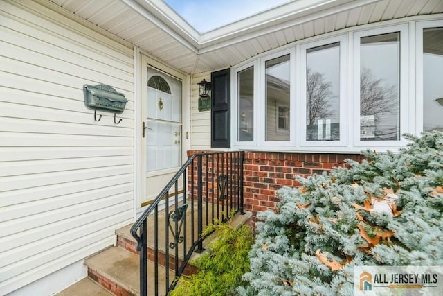 view of exterior entry featuring brick siding