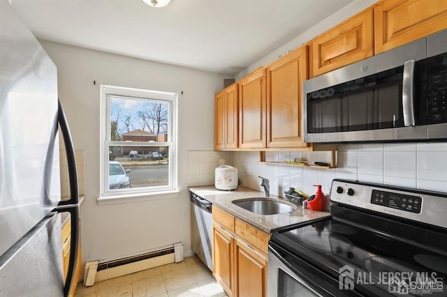 kitchen featuring a baseboard radiator, appliances with stainless steel finishes, sink, backsplash, and light tile patterned flooring