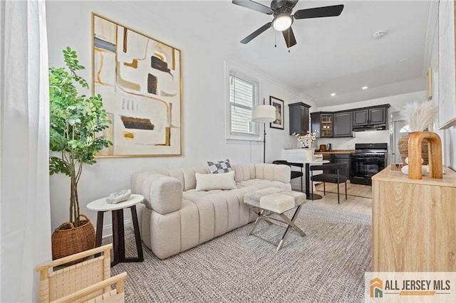 living room with recessed lighting, a ceiling fan, and light wood finished floors