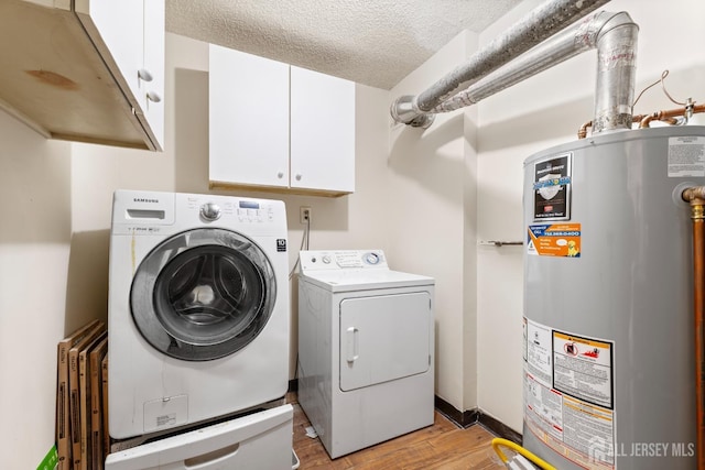255 Hampshire Ct, Piscataway, NJ 08854 - laundry room with gas water heater, cabinet space, washing machine and clothes dryer, light wood-style floors, and a textured ceiling