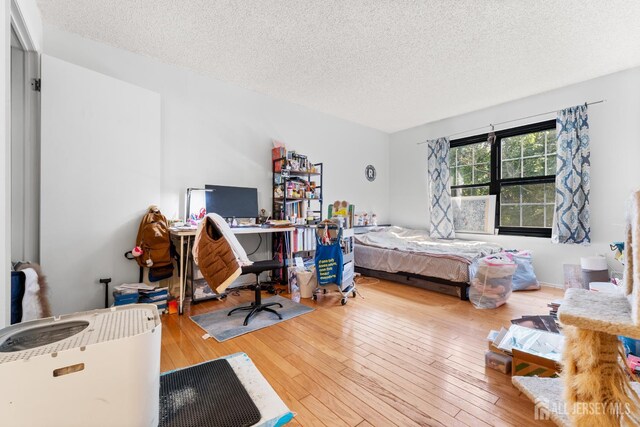 255 Hampshire Ct, Piscataway, NJ 08854 - bedroom with a textured ceiling and wood-type flooring