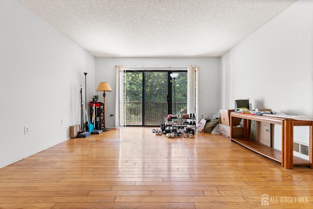 255 Hampshire Ct, Piscataway, NJ 08854 - exercise area with hardwood / wood-style flooring and a textured ceiling