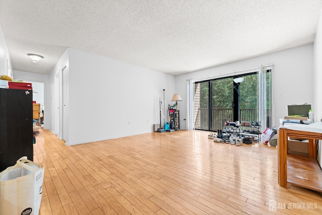 255 Hampshire Ct, Piscataway, NJ 08854 - exercise room with a textured ceiling and light wood finished floors