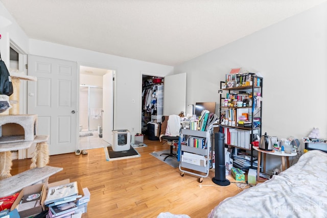 255 Hampshire Ct, Piscataway, NJ 08854 - bedroom with light wood-type flooring, connected bathroom, and a wood stove