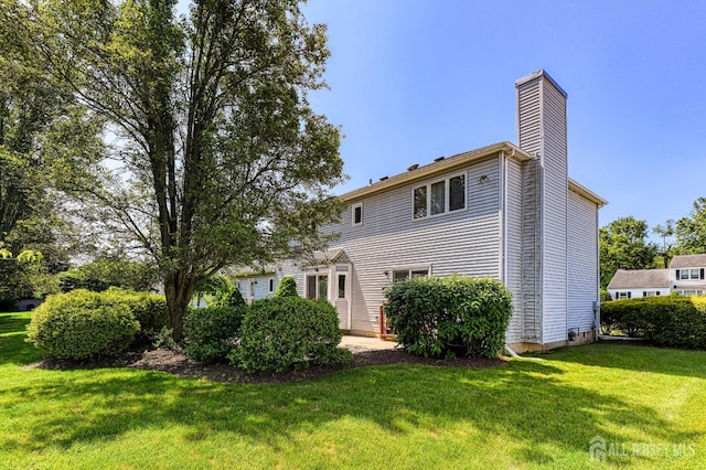 38 Silver Holw, North Brunswick, NJ 08902 - rear view of property featuring a chimney and a yard