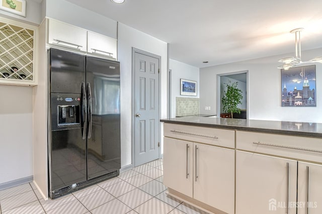 38 Silver Holw, North Brunswick, NJ 08902 - kitchen featuring black fridge, light tile patterned floors, white cabinetry, and hanging light fixtures