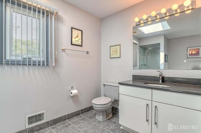 38 Silver Holw, North Brunswick, NJ 08902 - full bath featuring a skylight, toilet, vanity, baseboards, and a shower with door