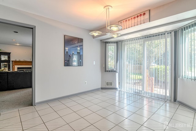 38 Silver Holw, North Brunswick, NJ 08902 - empty room with plenty of natural light, baseboards, a fireplace, and light tile patterned floors