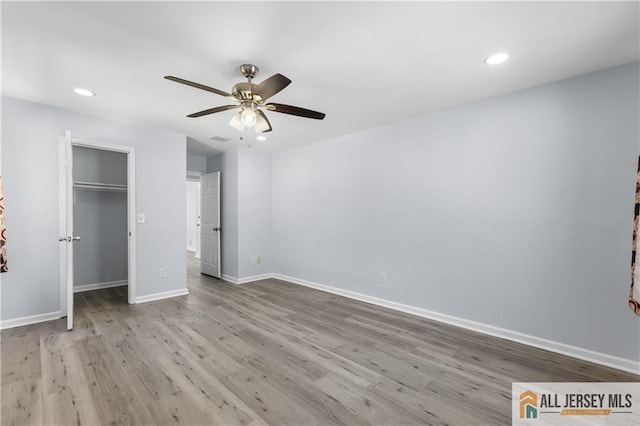 unfurnished bedroom featuring ceiling fan, recessed lighting, wood finished floors, and baseboards