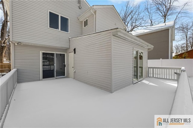 rear view of house with a patio and fence