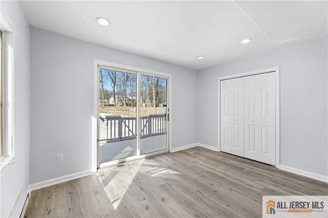 unfurnished bedroom featuring access to outside, recessed lighting, baseboards, and wood finished floors