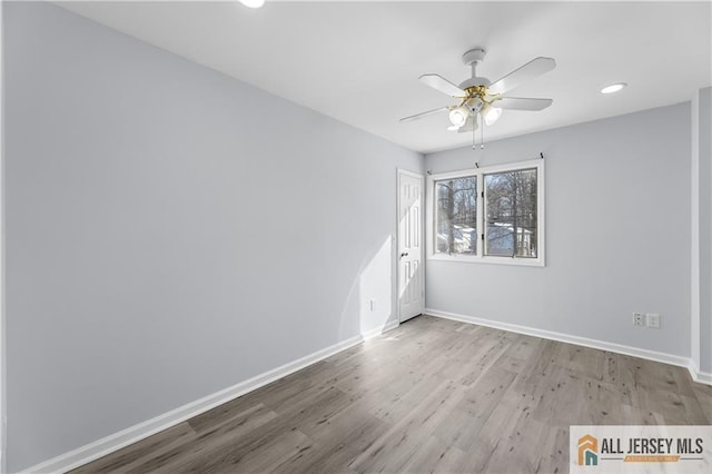 unfurnished room featuring recessed lighting, wood finished floors, a ceiling fan, and baseboards