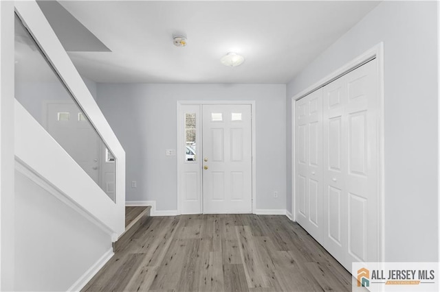 foyer featuring wood finished floors and baseboards