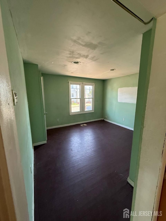 154 Townsend St, New Brunswick, NJ 08901 - unfurnished room with baseboards and dark wood-style flooring