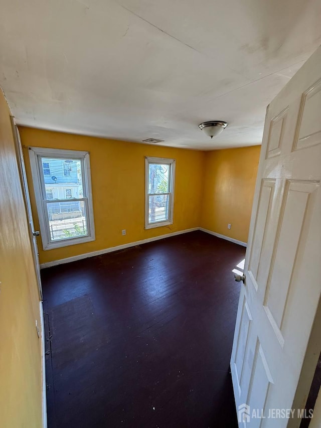 154 Townsend St, New Brunswick, NJ 08901 - empty room with baseboards and dark wood-type flooring