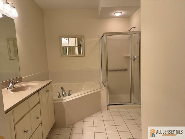 bathroom with tile patterned flooring, a garden tub, a shower stall, and vanity