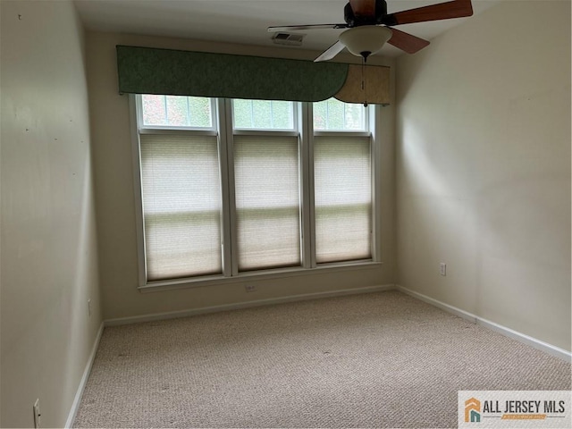 spare room featuring a ceiling fan, carpet flooring, visible vents, and baseboards