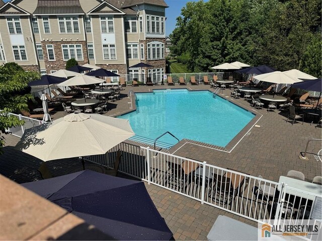 view of swimming pool with a patio