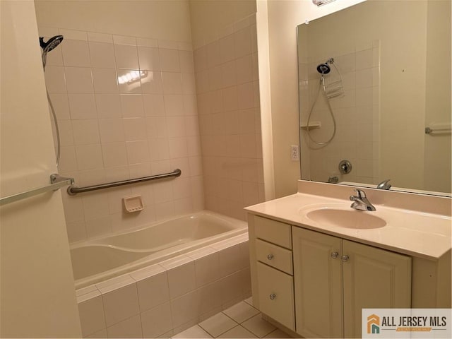 full bathroom with tiled shower / bath, vanity, and tile patterned floors