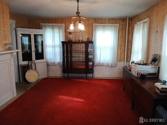 interior space with dark carpet and a notable chandelier